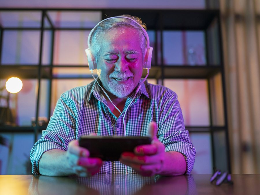 A customer watching something on a tablet at home, online on the new service