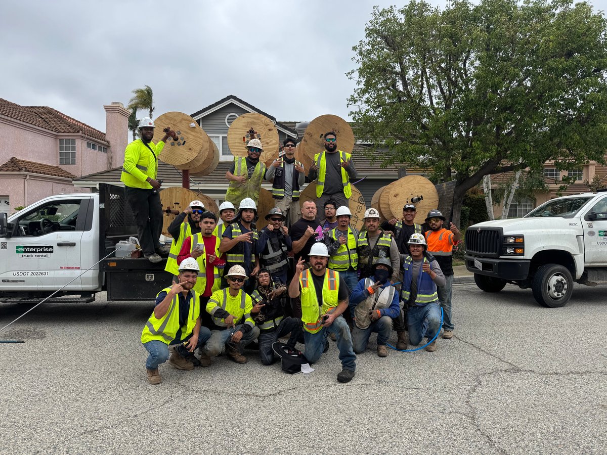 The Aspire Fiber construction crew posing with fiber
          cable spools and trucks on a Moorpark street